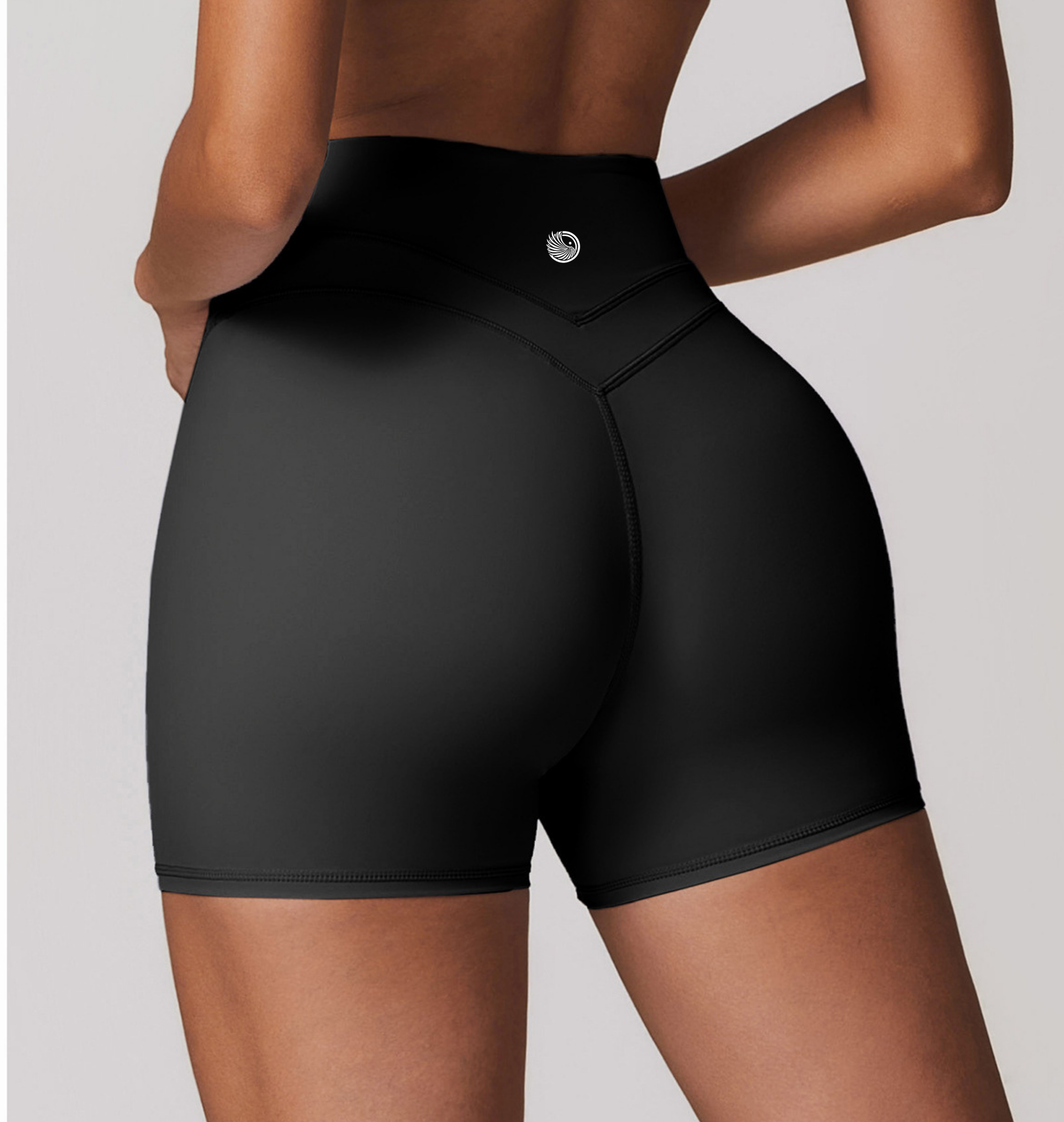 Black high-waisted shorts worn by a person on a plain background