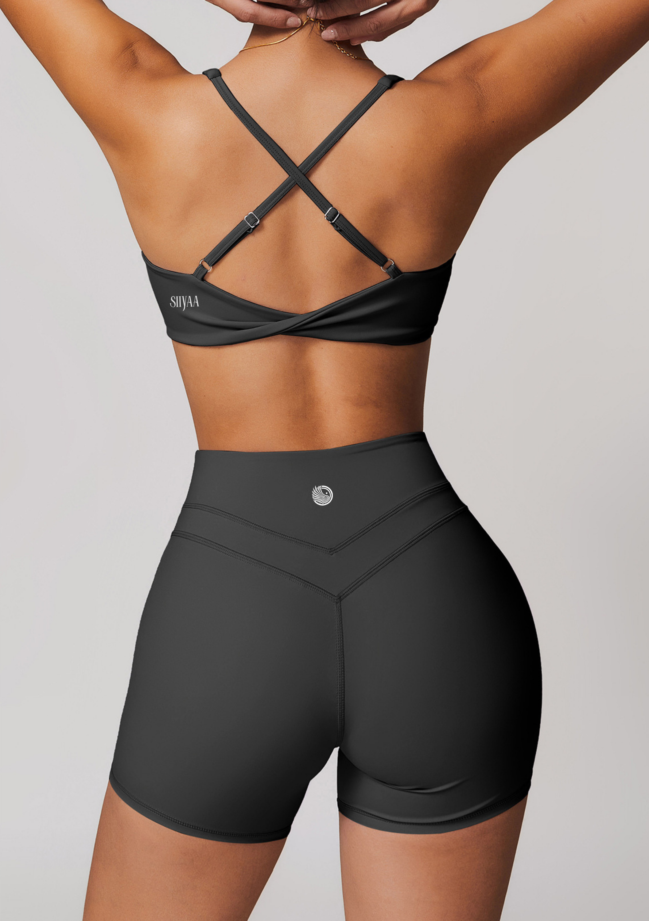 Black athletic shorts with a criss-cross design on a white background