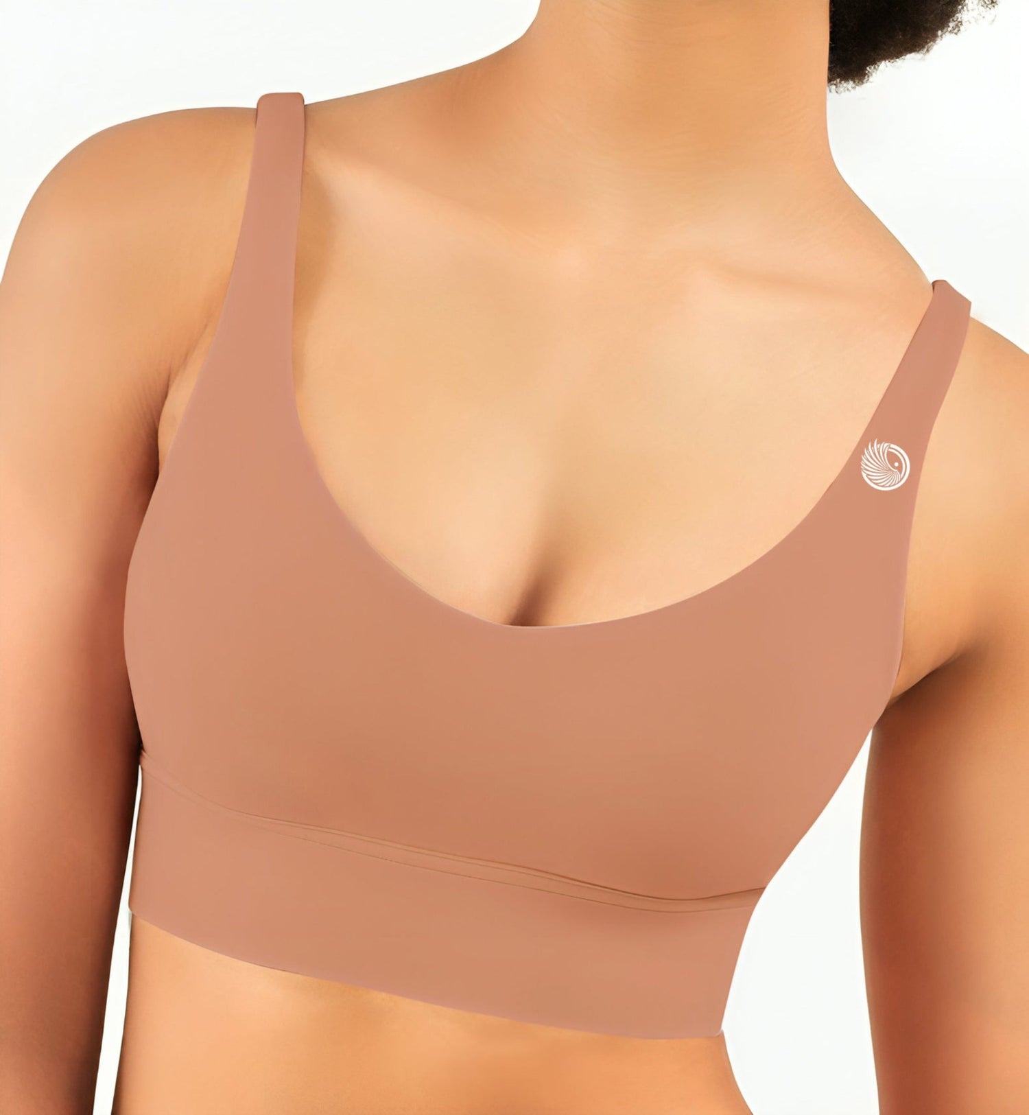 Beige sports bra worn by a person on a white background