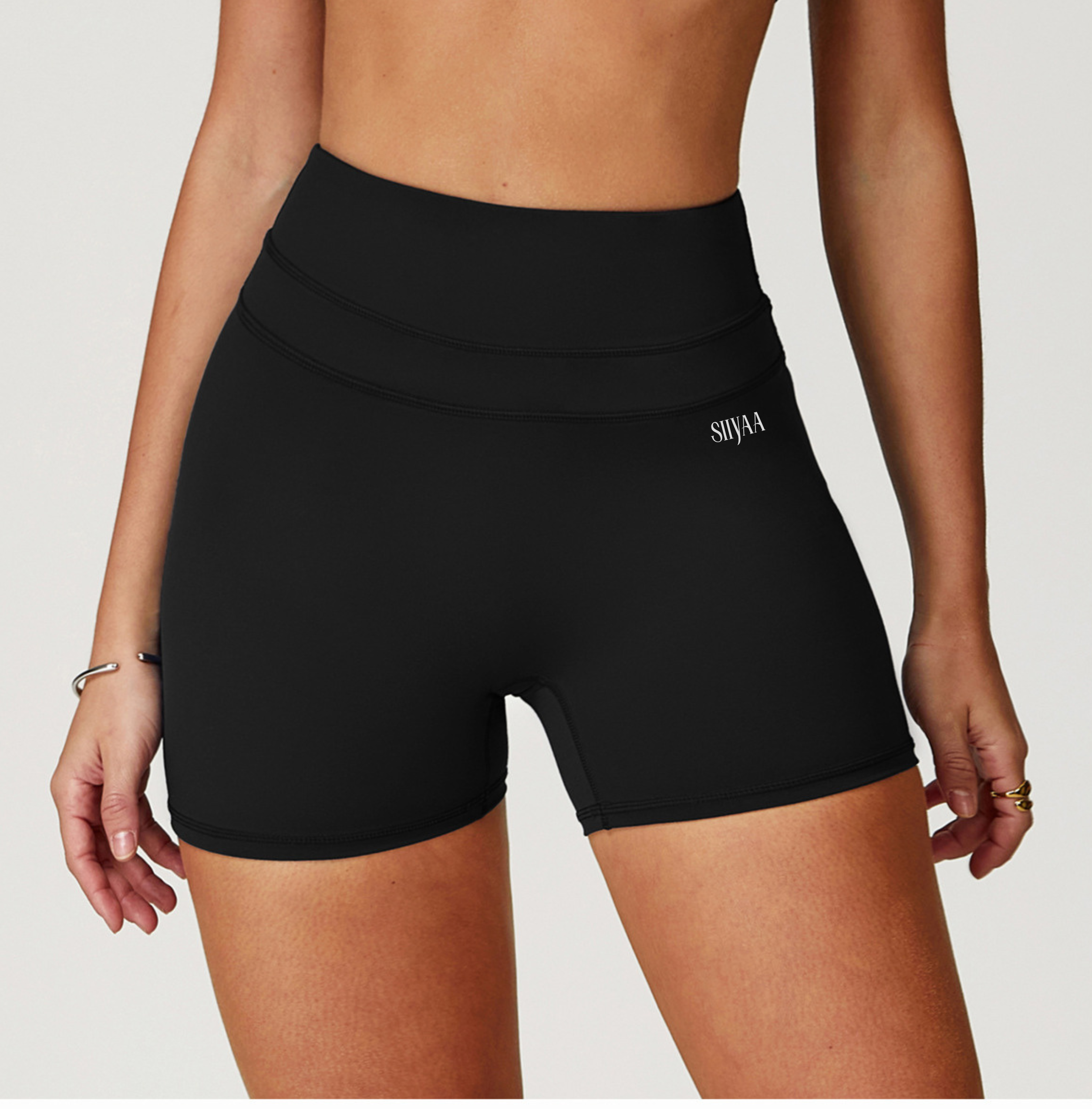 Black athletic shorts worn by a person on a white background