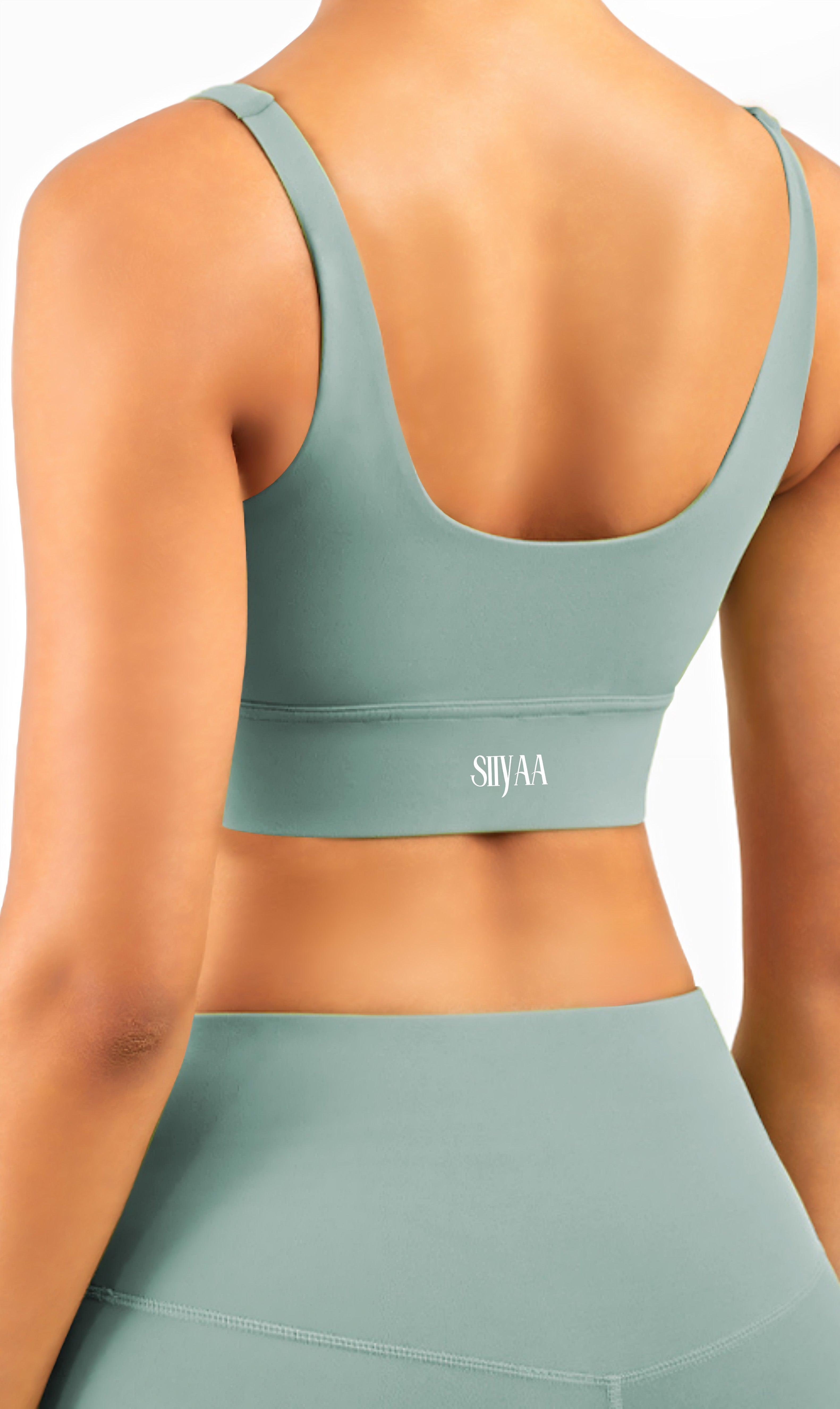 Green sports bra and leggings set with 'SHYAA' branding on a neutral background