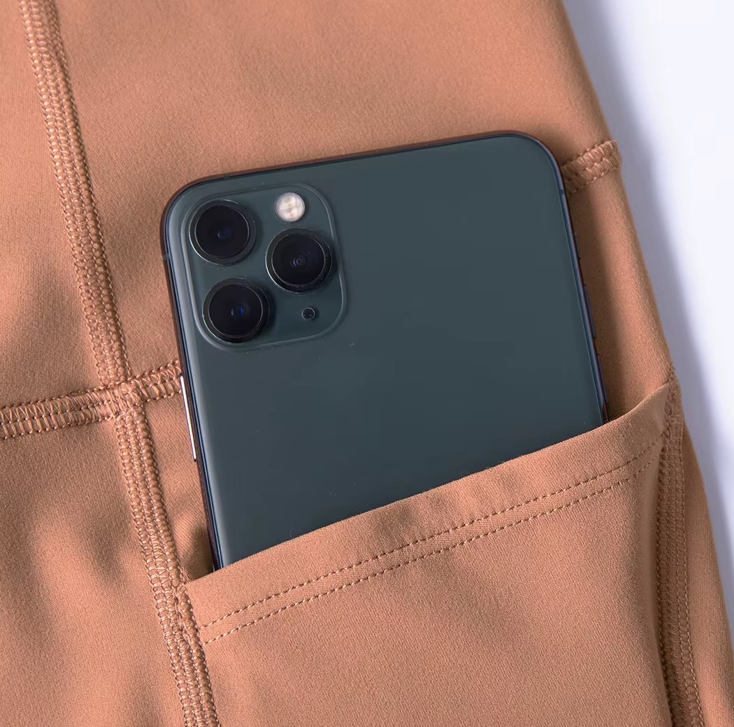 Phone in a brown pocket with a white background