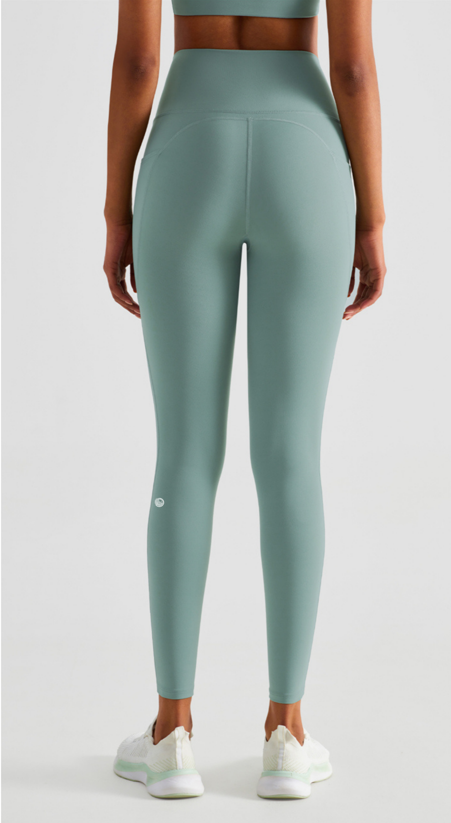 Person wearing green leggings on a white background